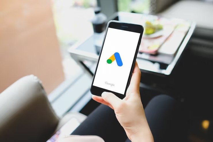 imgi_9_young-girl-pointing-google-ads-smart-phone-screen-pandemic-coronavirus-prevention-google-ads-is-online-platform-advertising-service-offering_21483-272